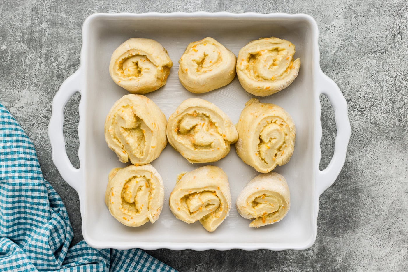 Orange roll dough spirals in a baking dish