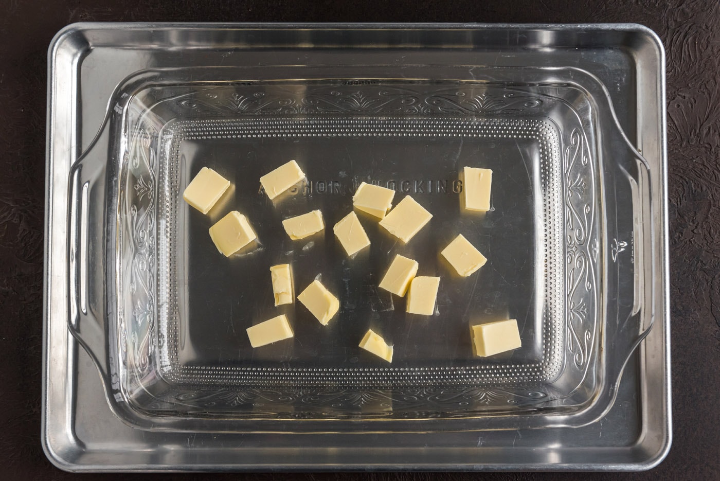 butter pats in a baking dish