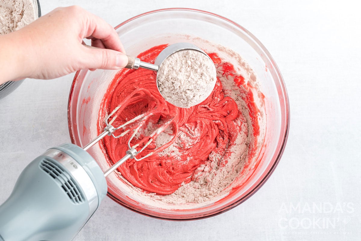 adding flour to bowl