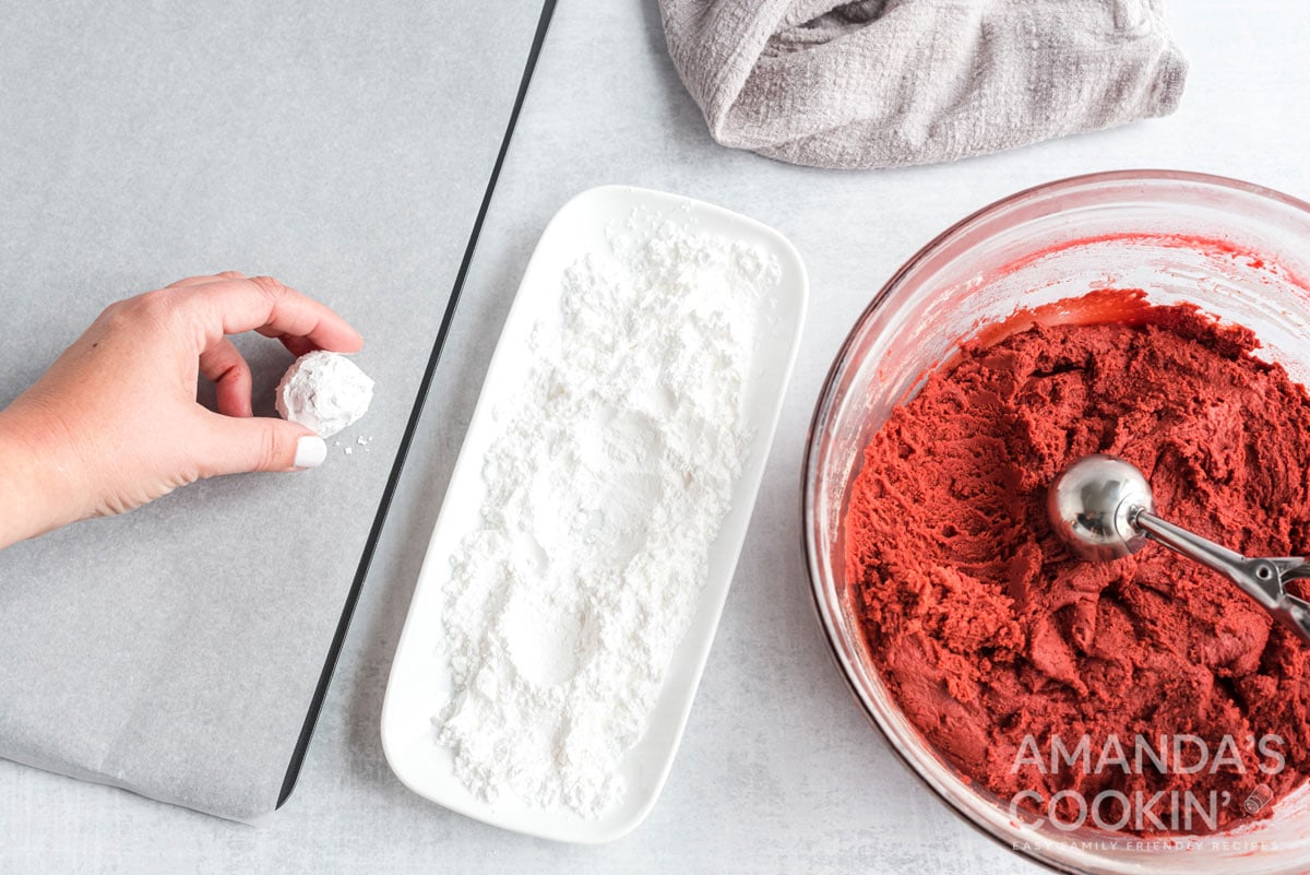 putting dough ball on cookie sheet