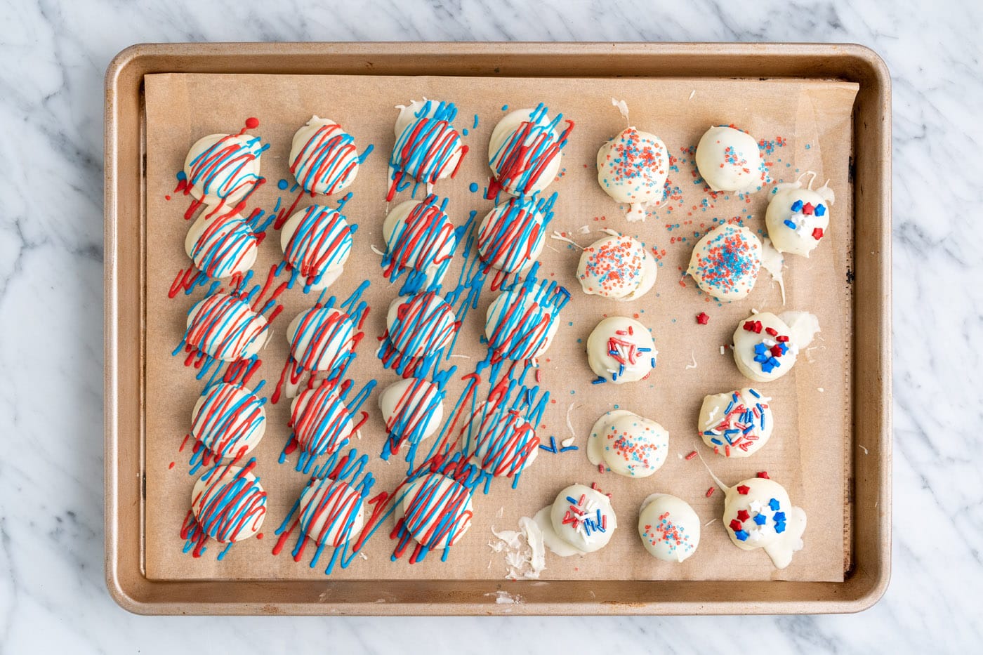 patriotic decorated oreo truffles on a baking sheet