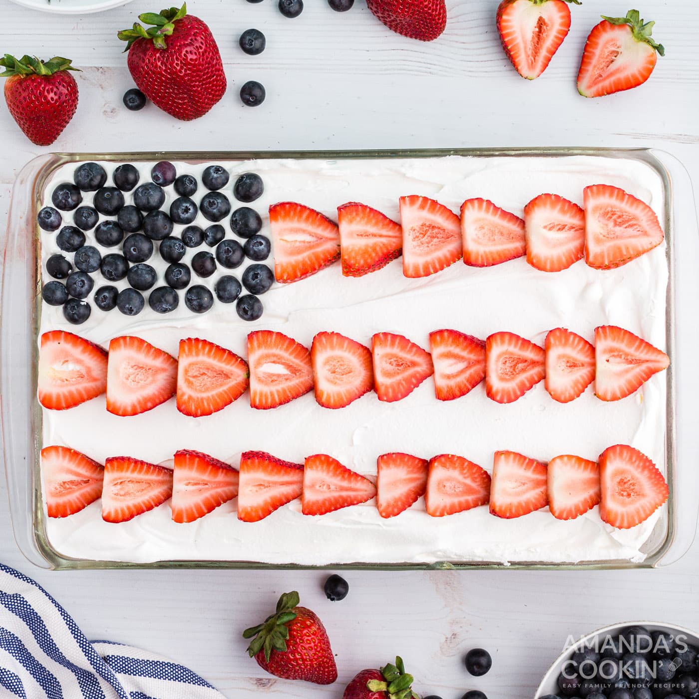 red white and blue poke cake decorated like a USA flag