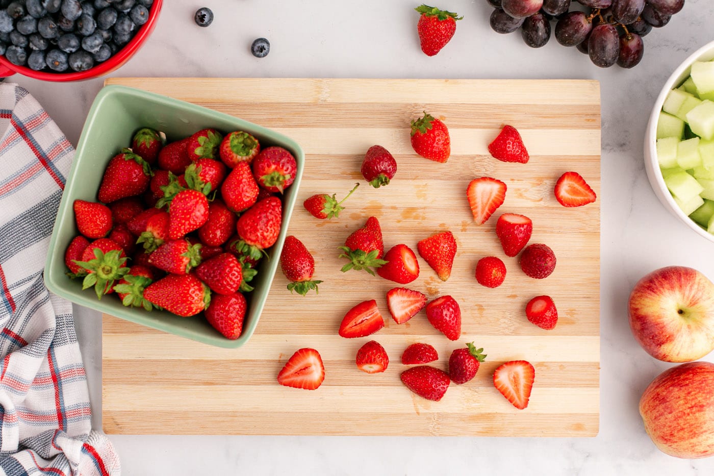 sliced strawberries on a cutting board