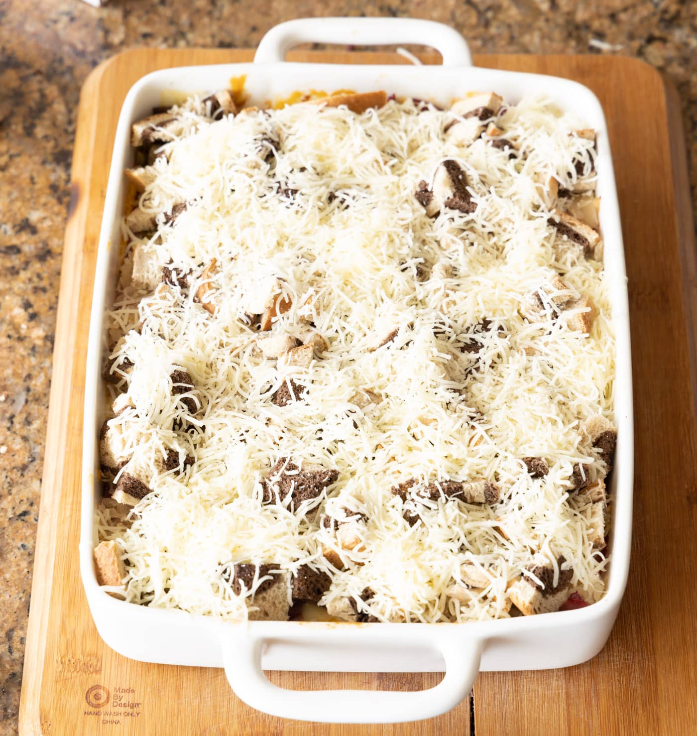 shredded Swiss cheese on top of reuben casserole