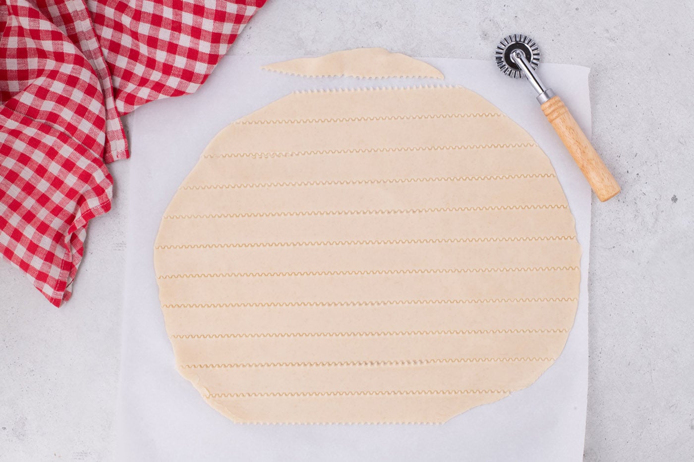 cutting strips of pie crust to make a lattice top