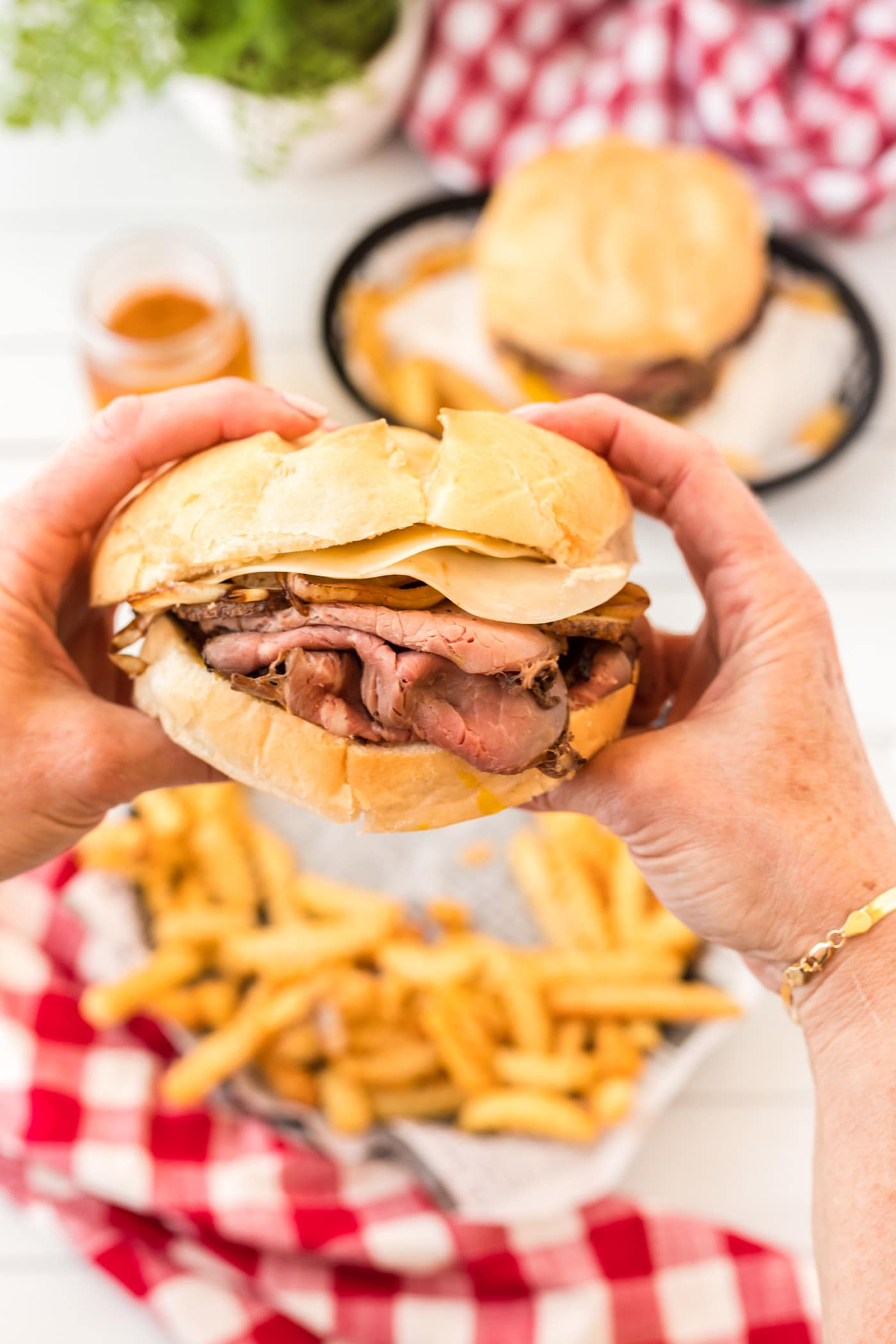 A Roast Beef Sandwich being held by two hands
