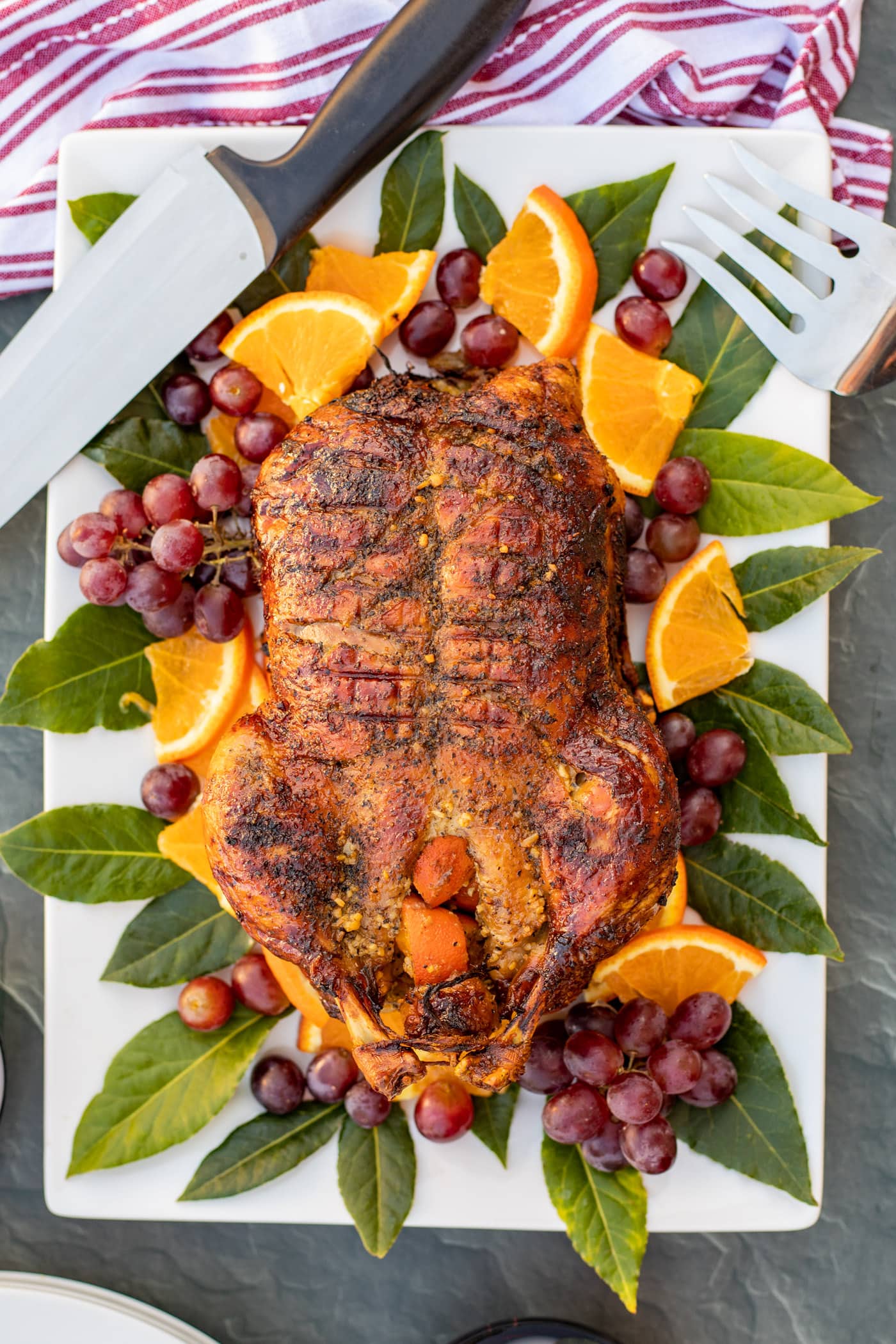 Roast Duck on a platter with a knife