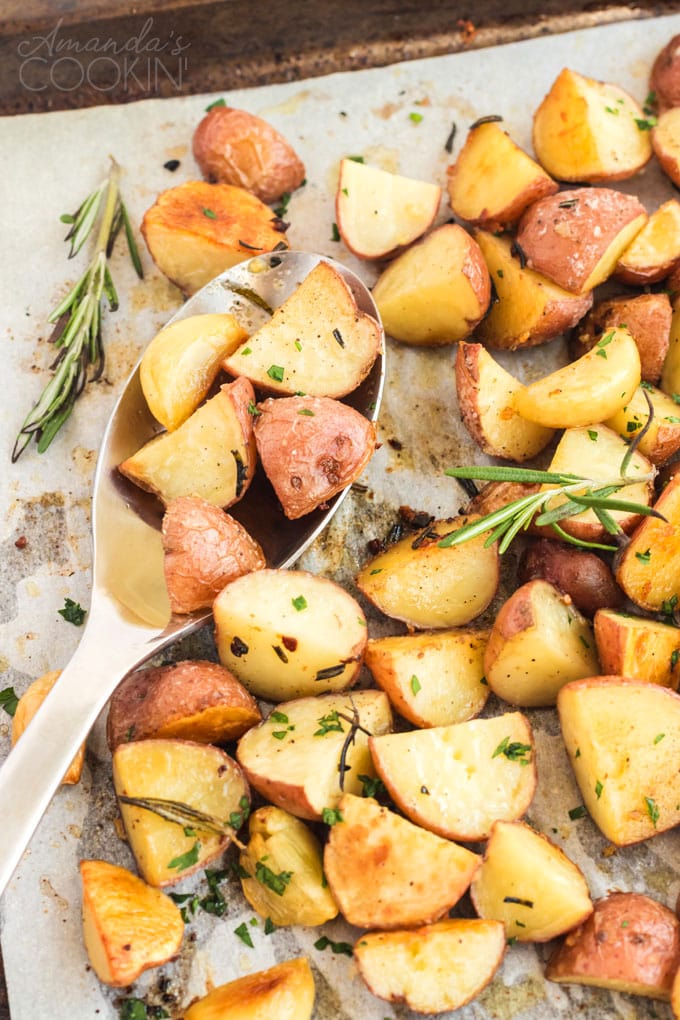 roast potatoes on a baking pan with spoon