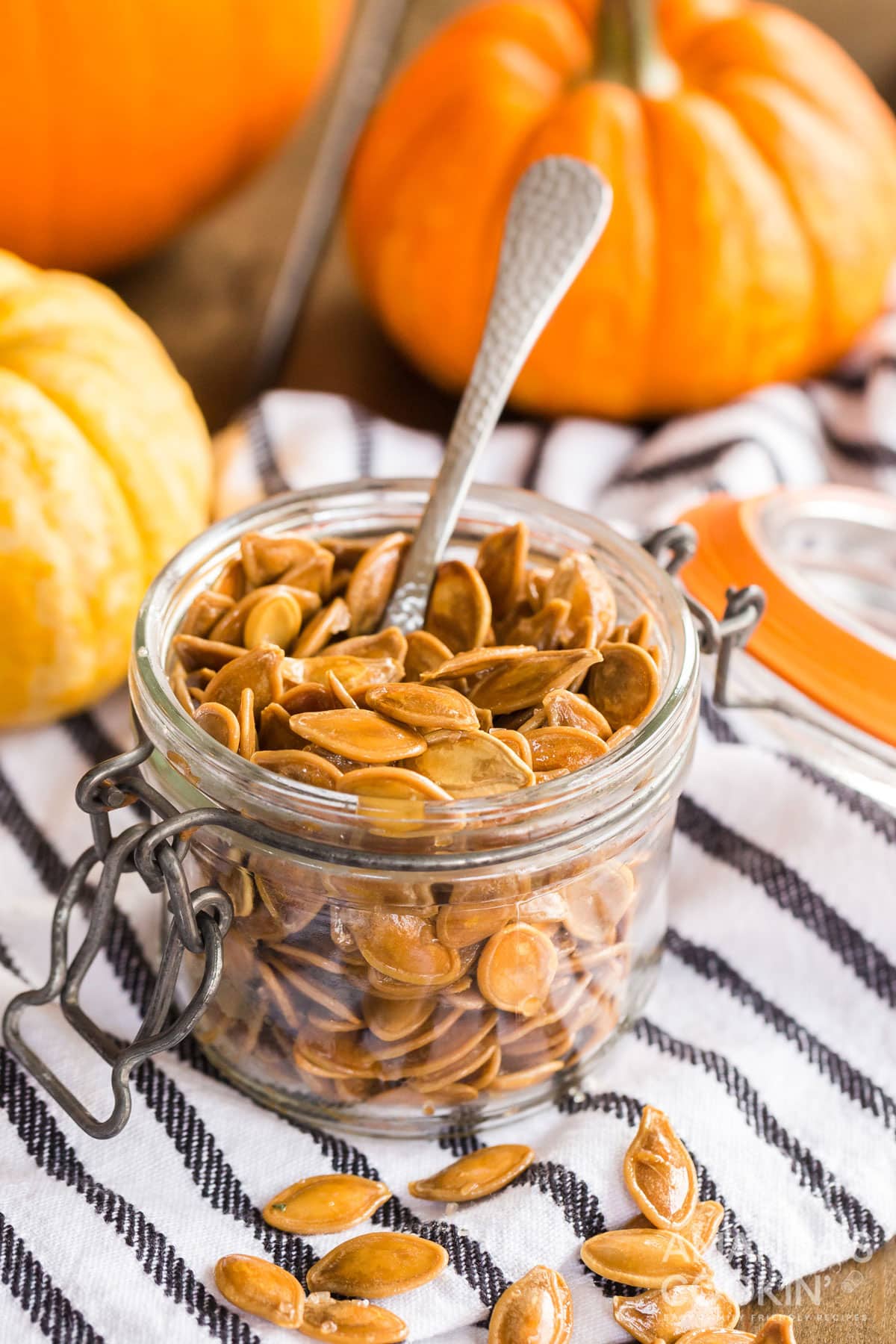 small jar of pumpkin seeds with a spoon