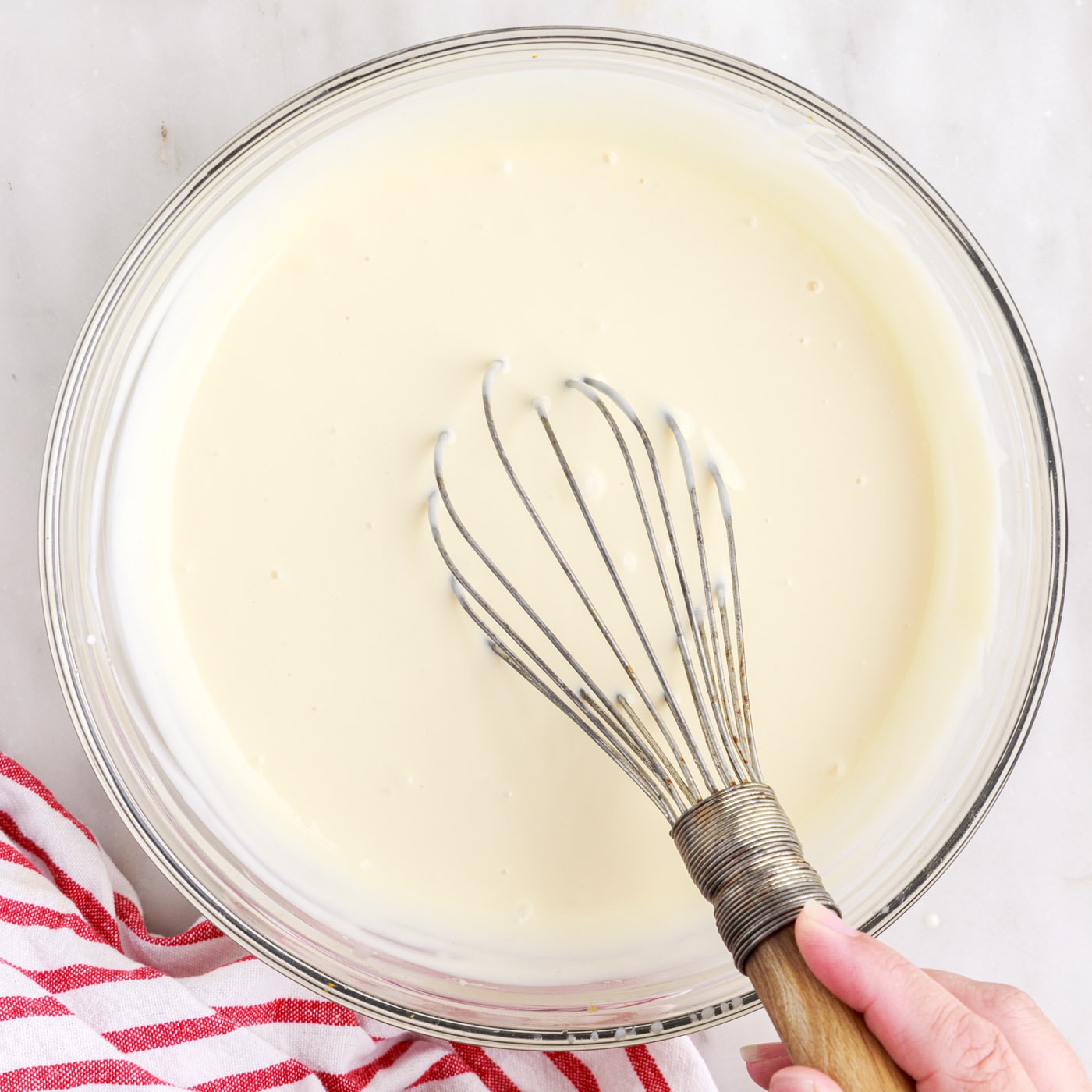 ingredients for rolled ice cream whisked in a bowl