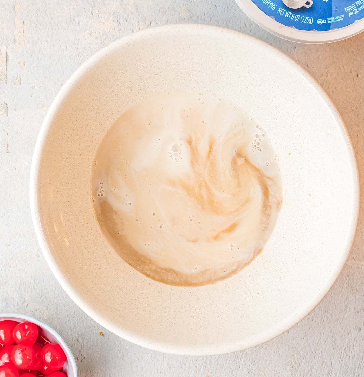 root beer, root beer flavoring, and heavy whipping cream in a bowl