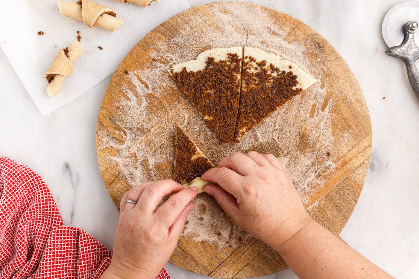 hands rolling rugelach dough
