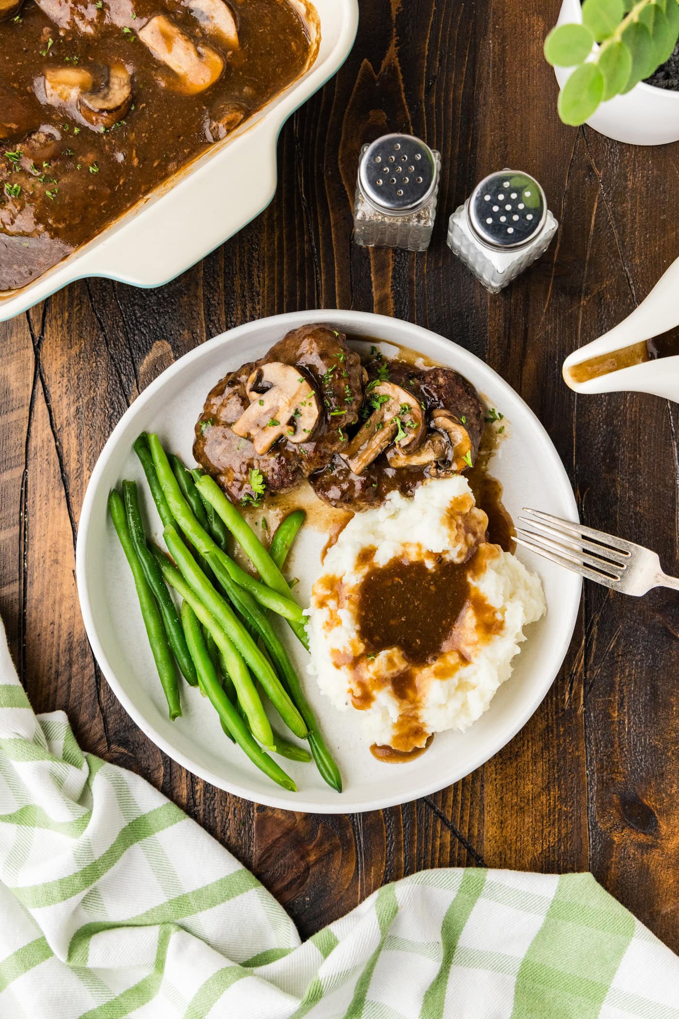 A plate of Salisbury steak on a table