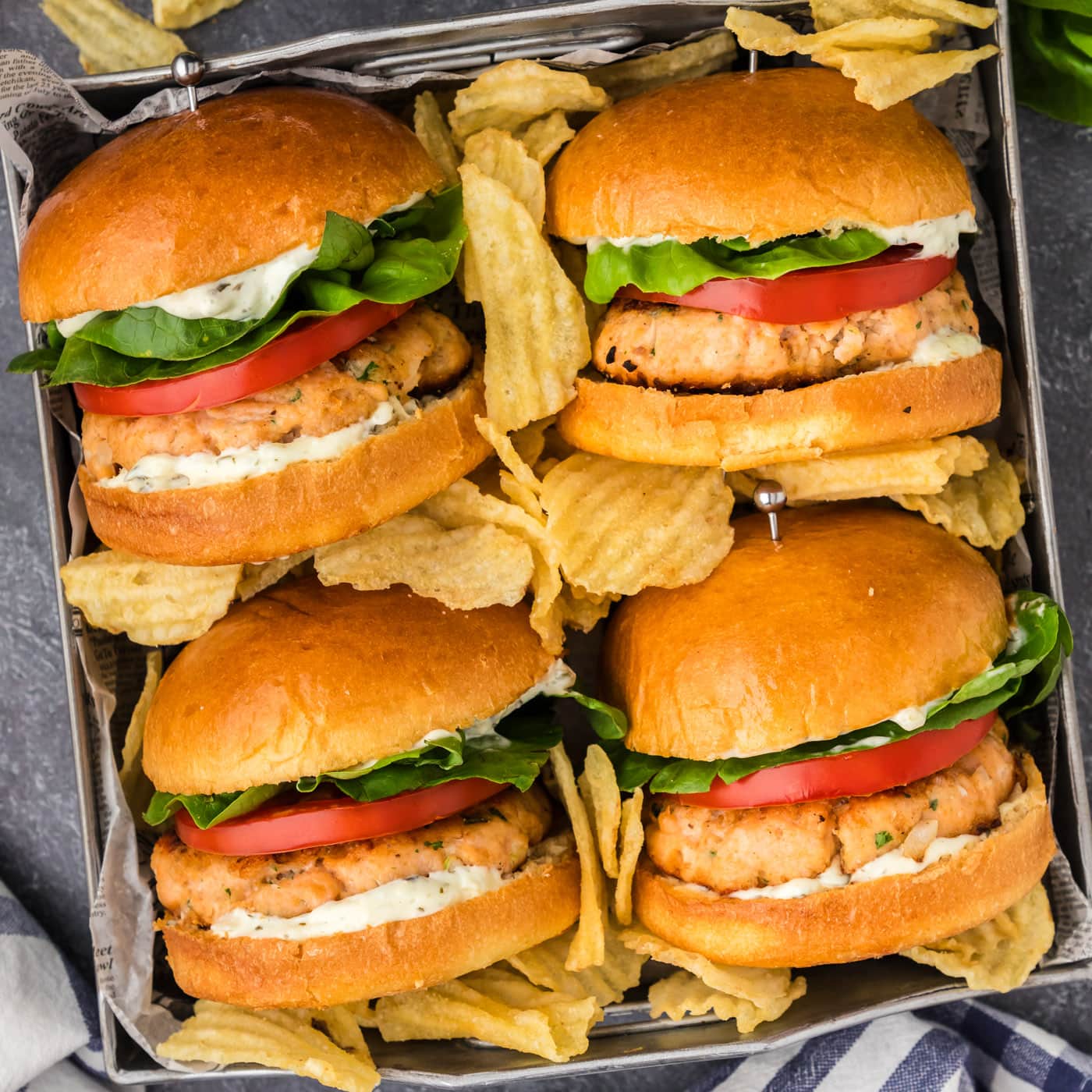 Four Salmon Burgers in a metal tray