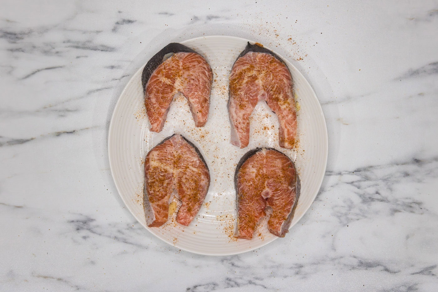 seasoned salmon steaks on a plate