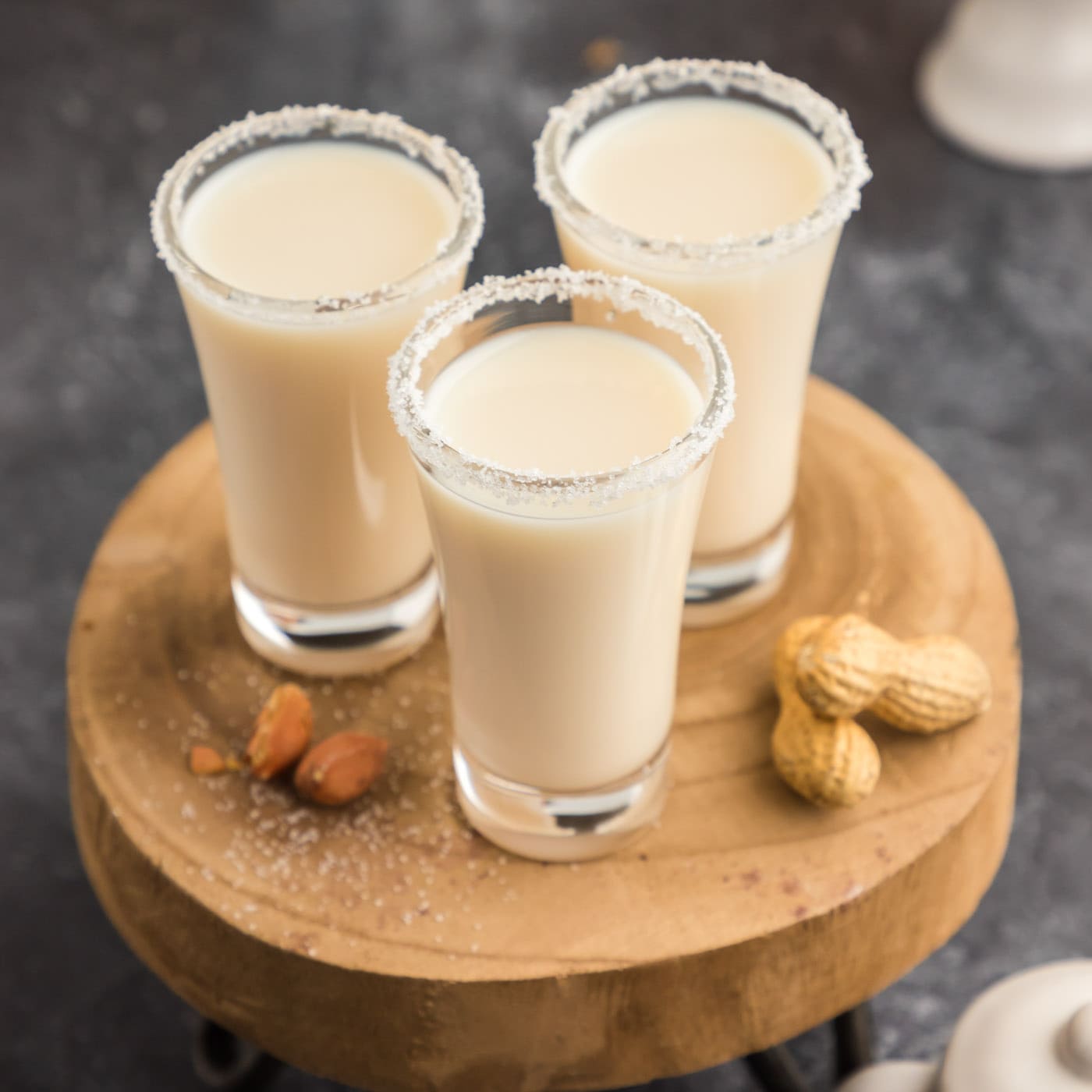 Three Salted Nut Roll Shots on a wooden tray