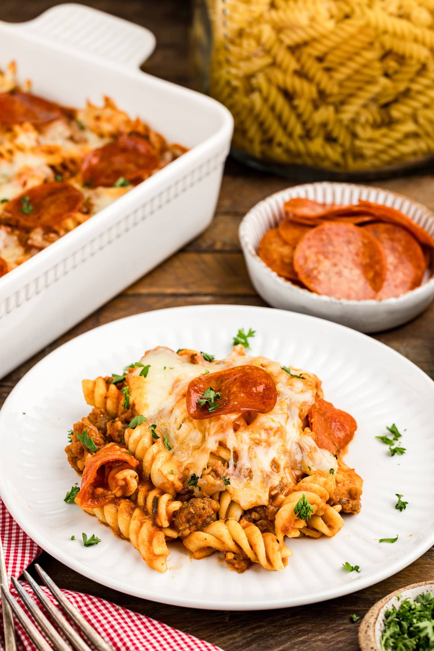 Serving of Sausage & Pepperoni Pizza Casserole on a white plate