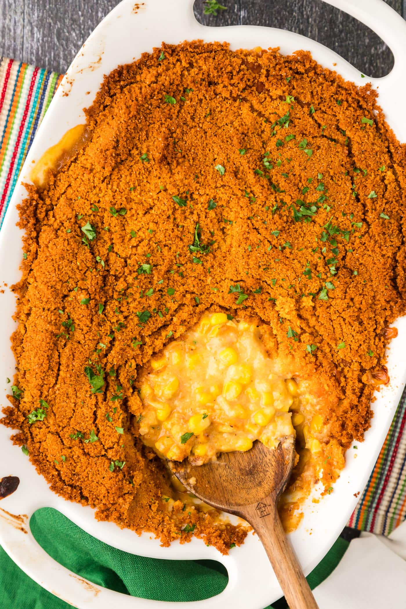 Pan of Scalloped Corn with a serving spoon in it
