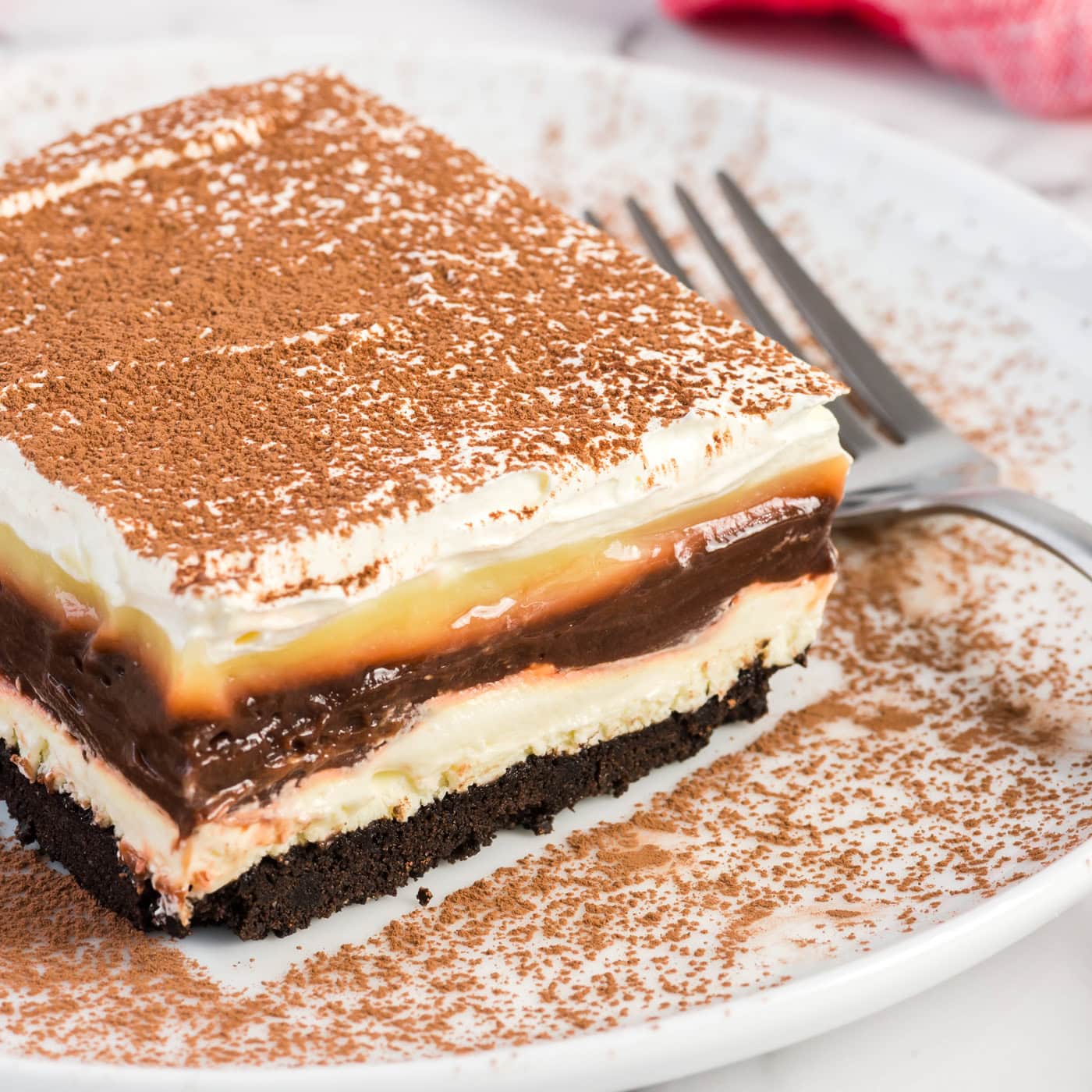 Close up photo of a slice of Sex in a Pan on a plate