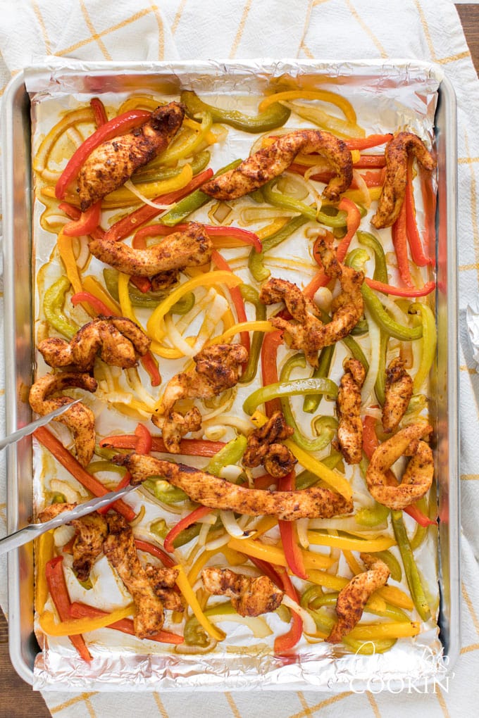 foil lined sheet pan with chicken fajita ingredients