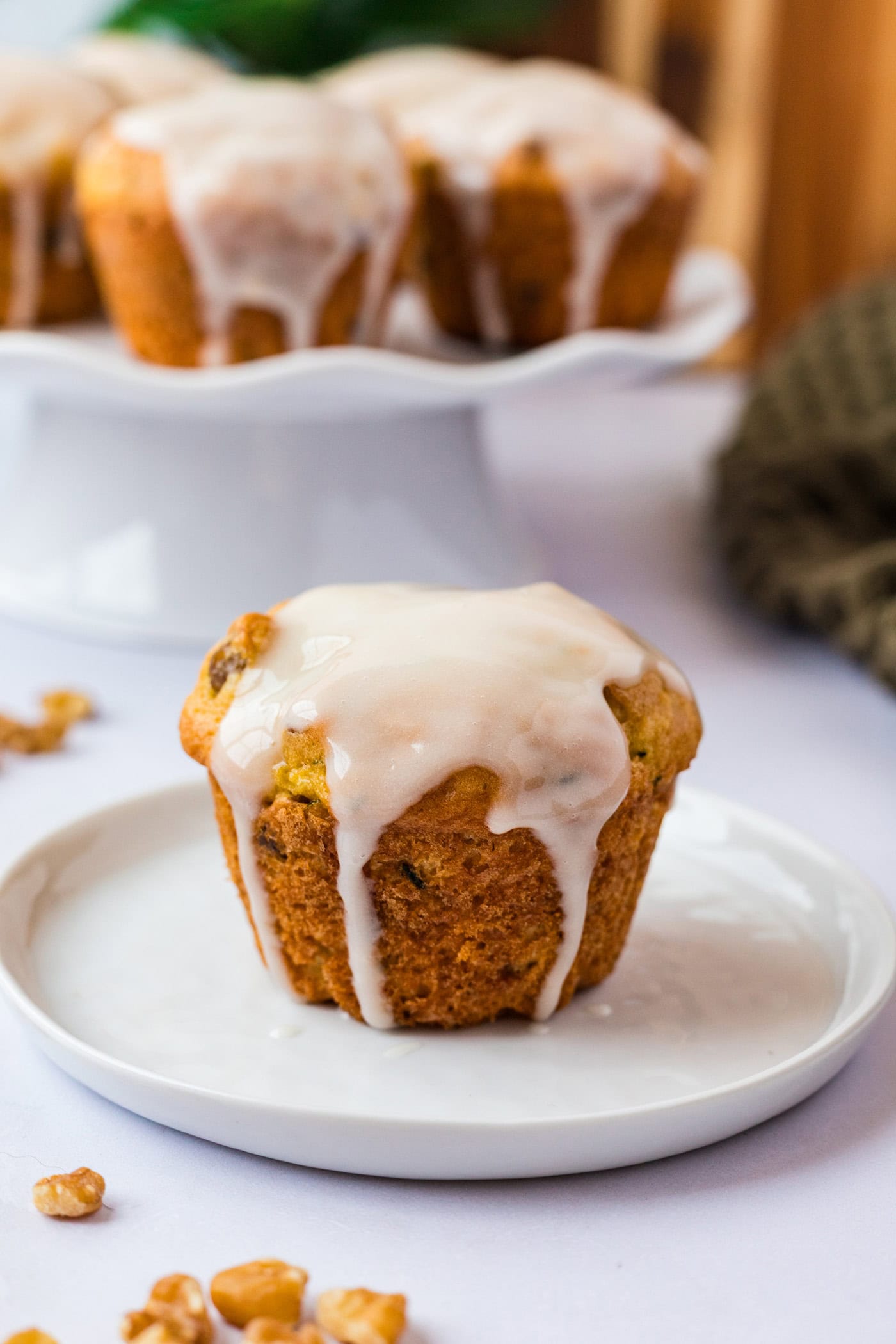 Shortcut Zucchini Muffins on a white plate with more muffins behind it