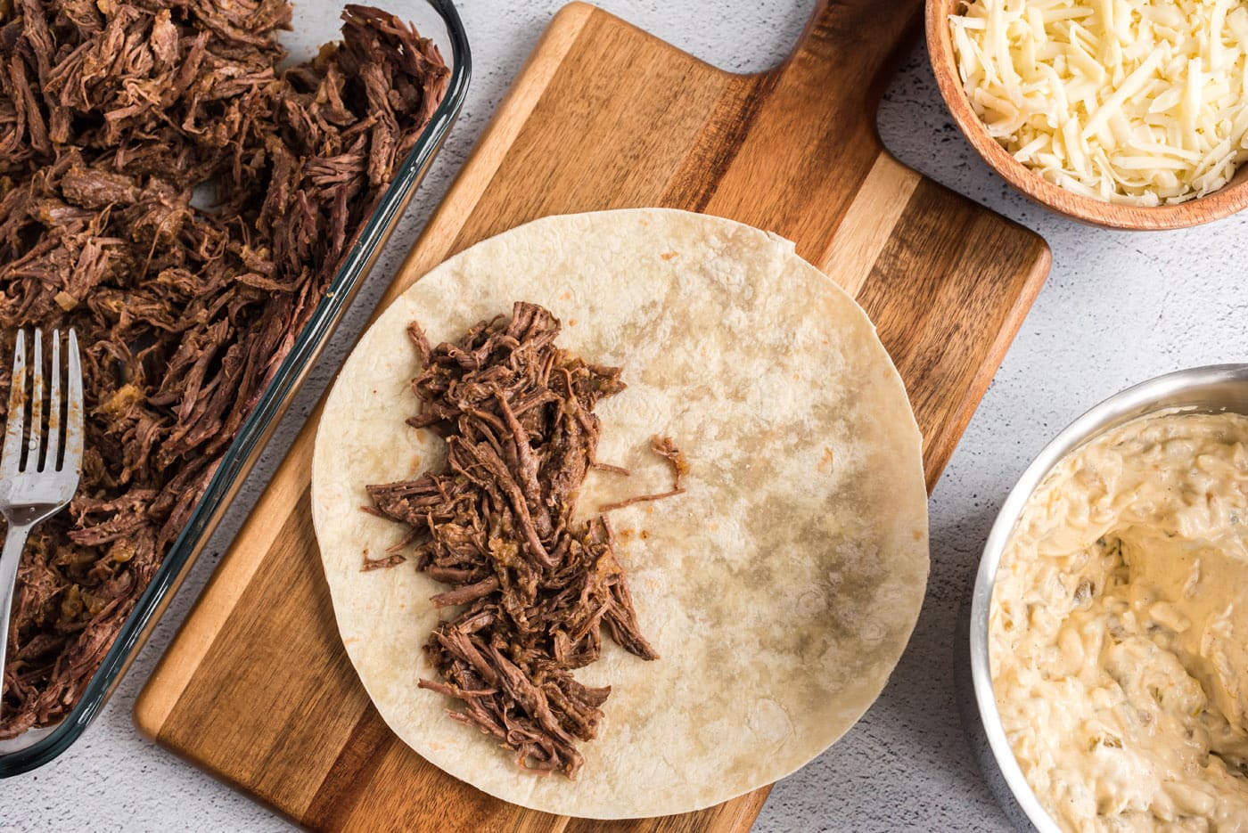 shredded beef on flour tortilla