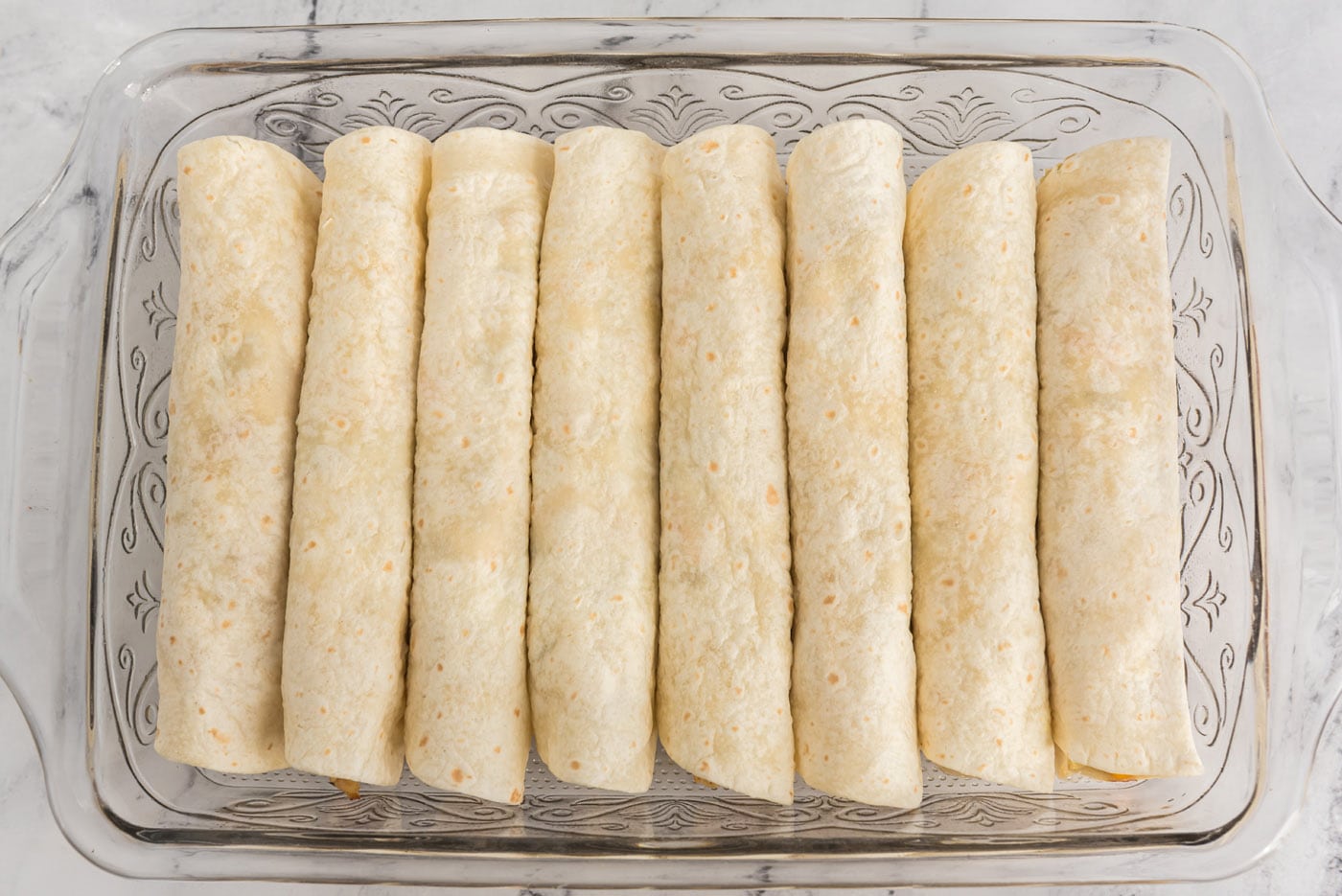 rolled enchiladas in a baking dish