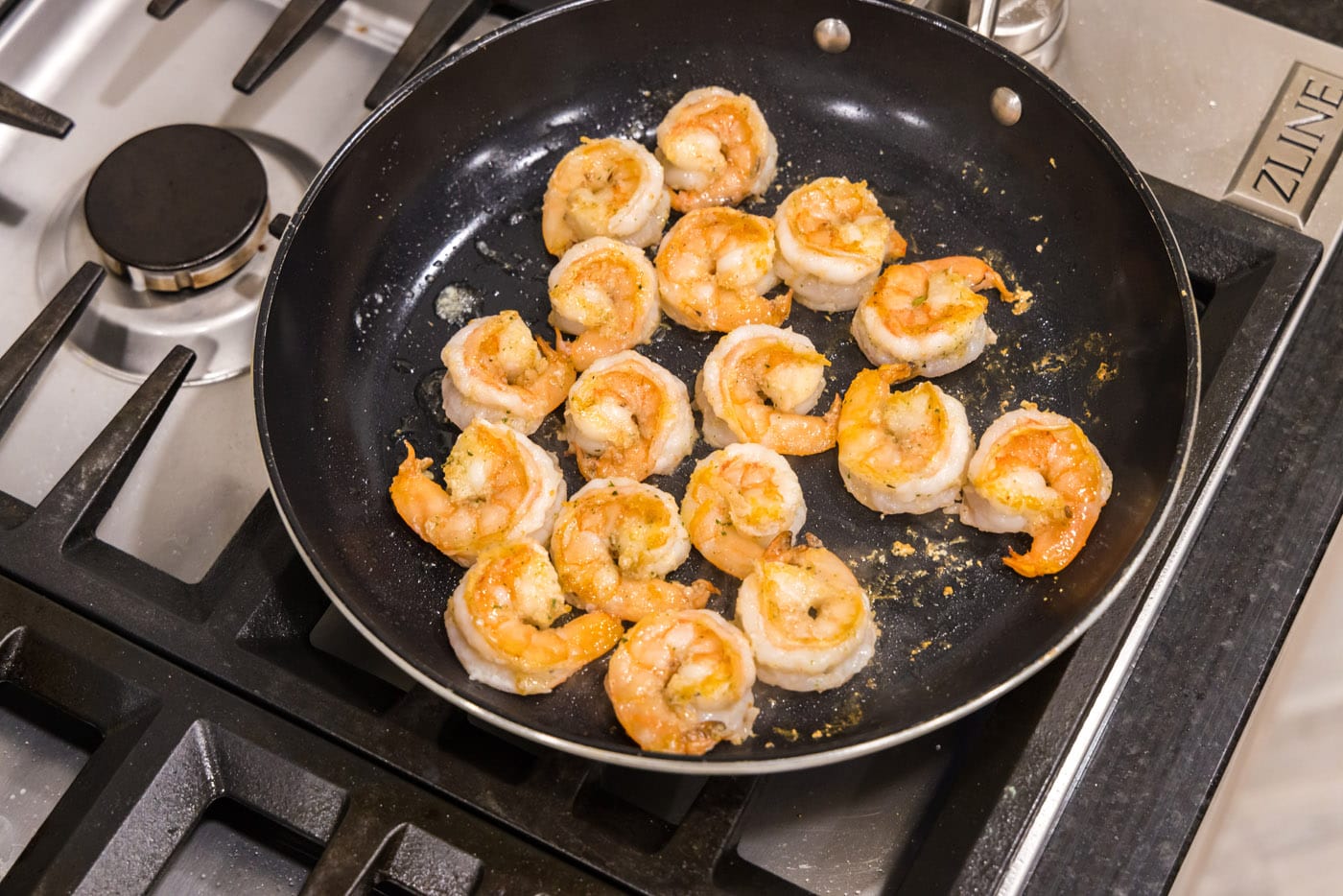 golden sauteed shrimp in a skillet
