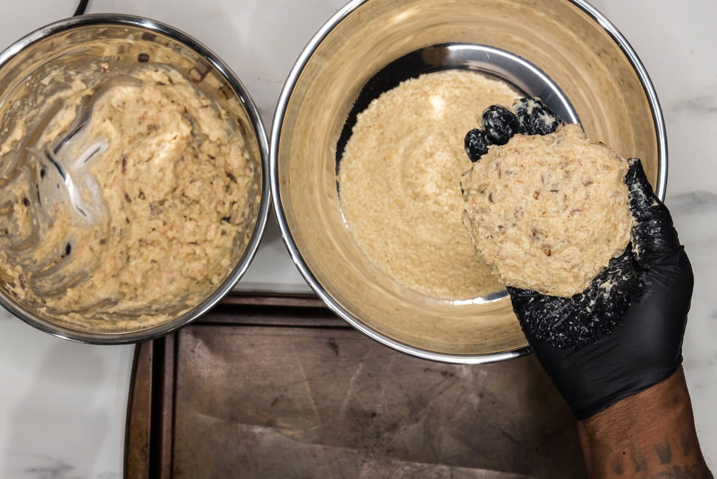 forming shrimp mixture into patties with gloved hand