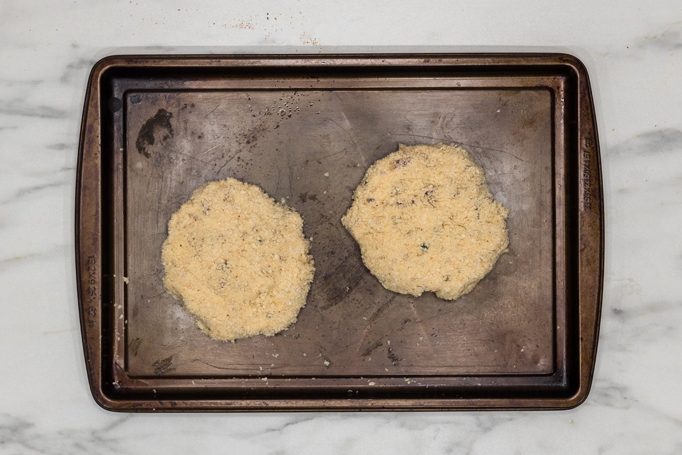 shrimp burger patties on a baking sheet