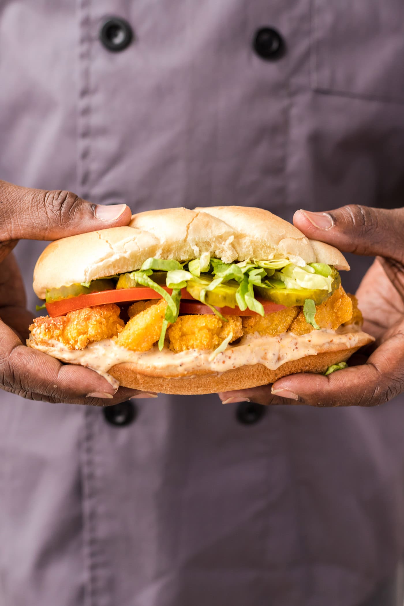 chef holding a Shrimp Po Boy