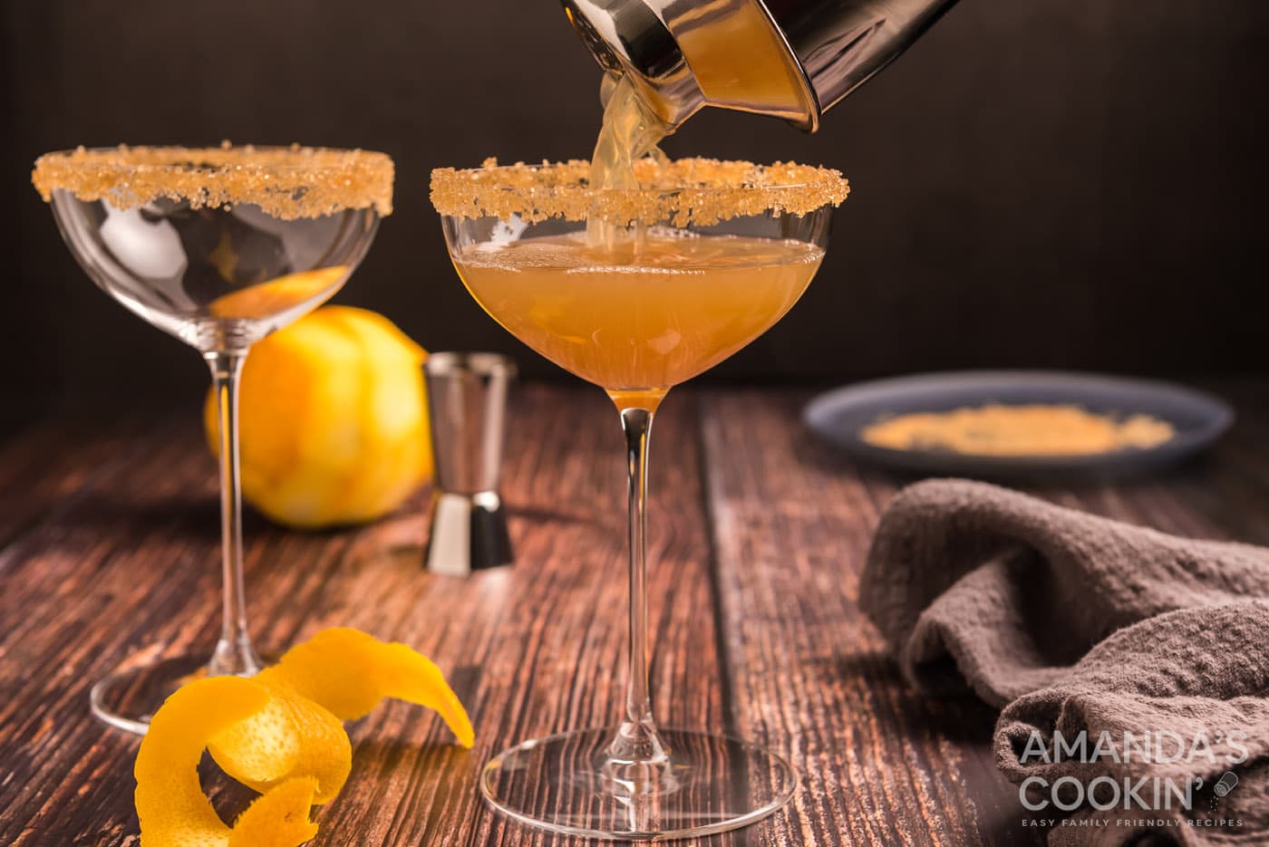 pouring sidecar cocktail into a glass