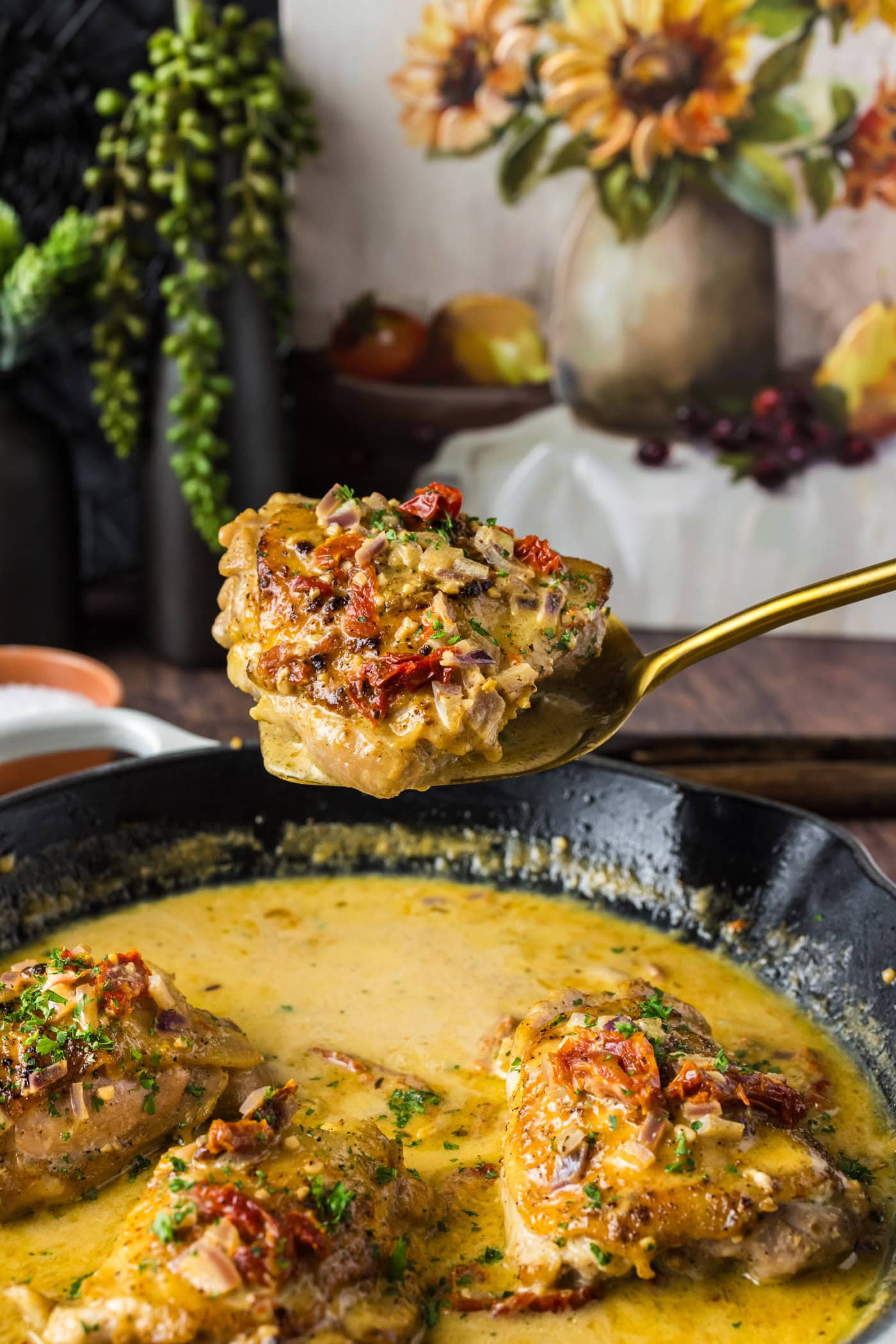 Skillet Chicken Thigh held up on a spatula
