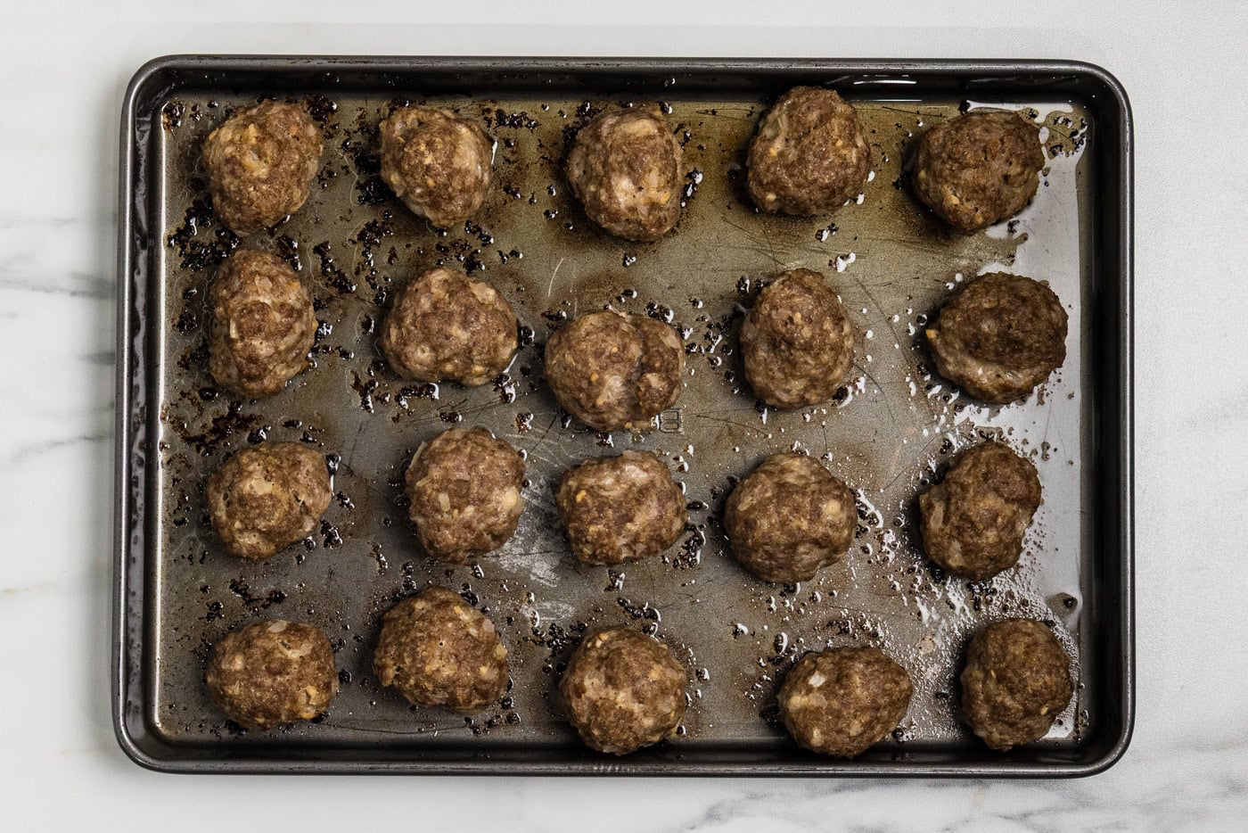 baked meatballs on baking sheet