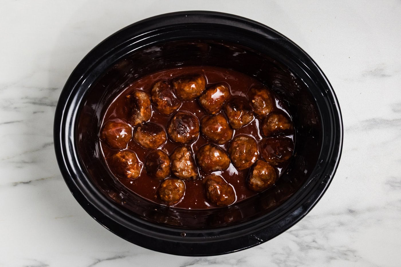 sauce mixed with meatballs in crockpot