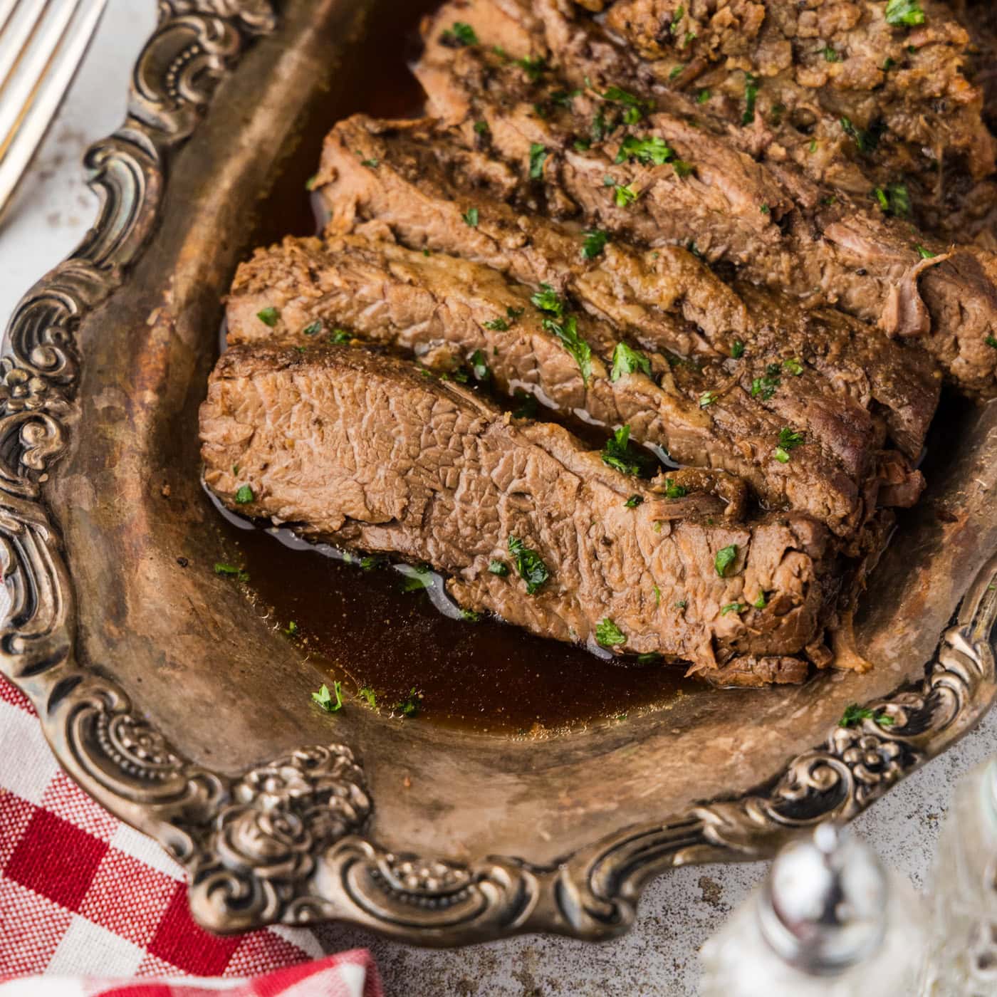 Slices of Slow Cooker Brisket on a silver platter
