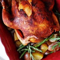 An overhead photo of slow roasted sticky chicken in a roasting pan.