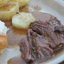 A close up photo of slow cooker roast with brandy sauce.