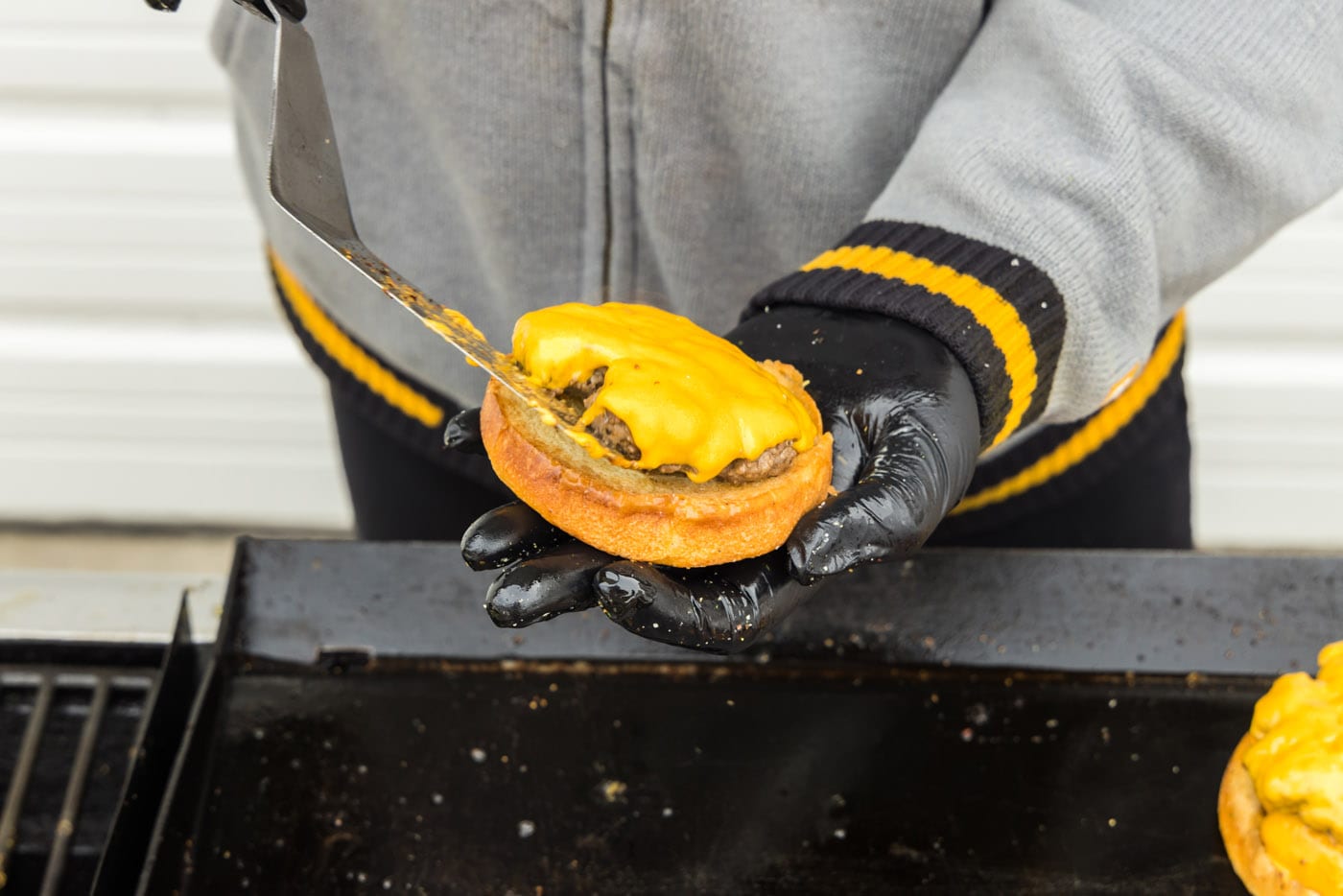 adding burger patty with cheese to a bun