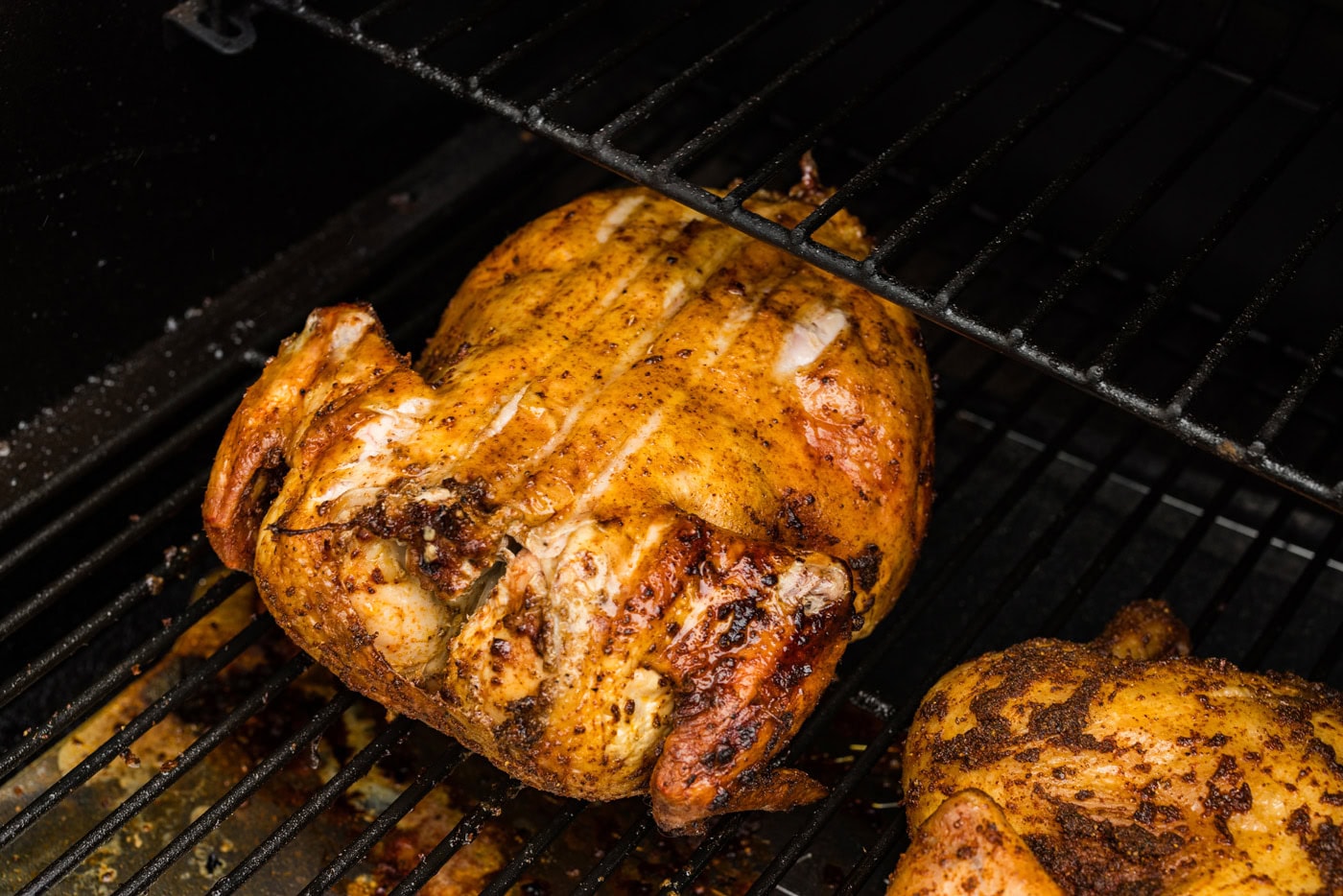 whole smoked chicken on grill grates