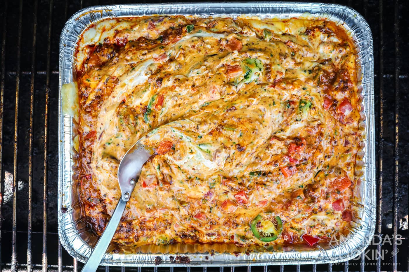 finished smoked queso dip in a pan inspired by tik tok