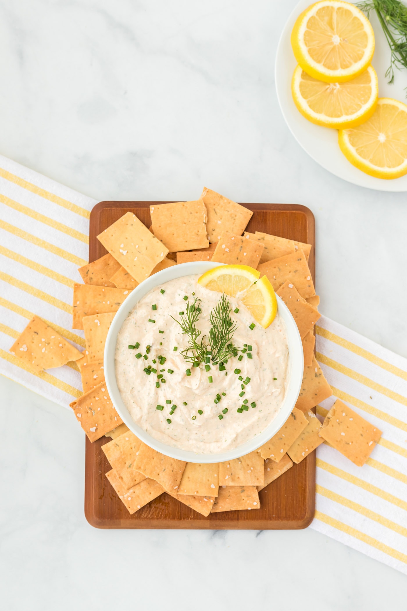 Smoked Salmon Dip in a bowl on a small cutting board