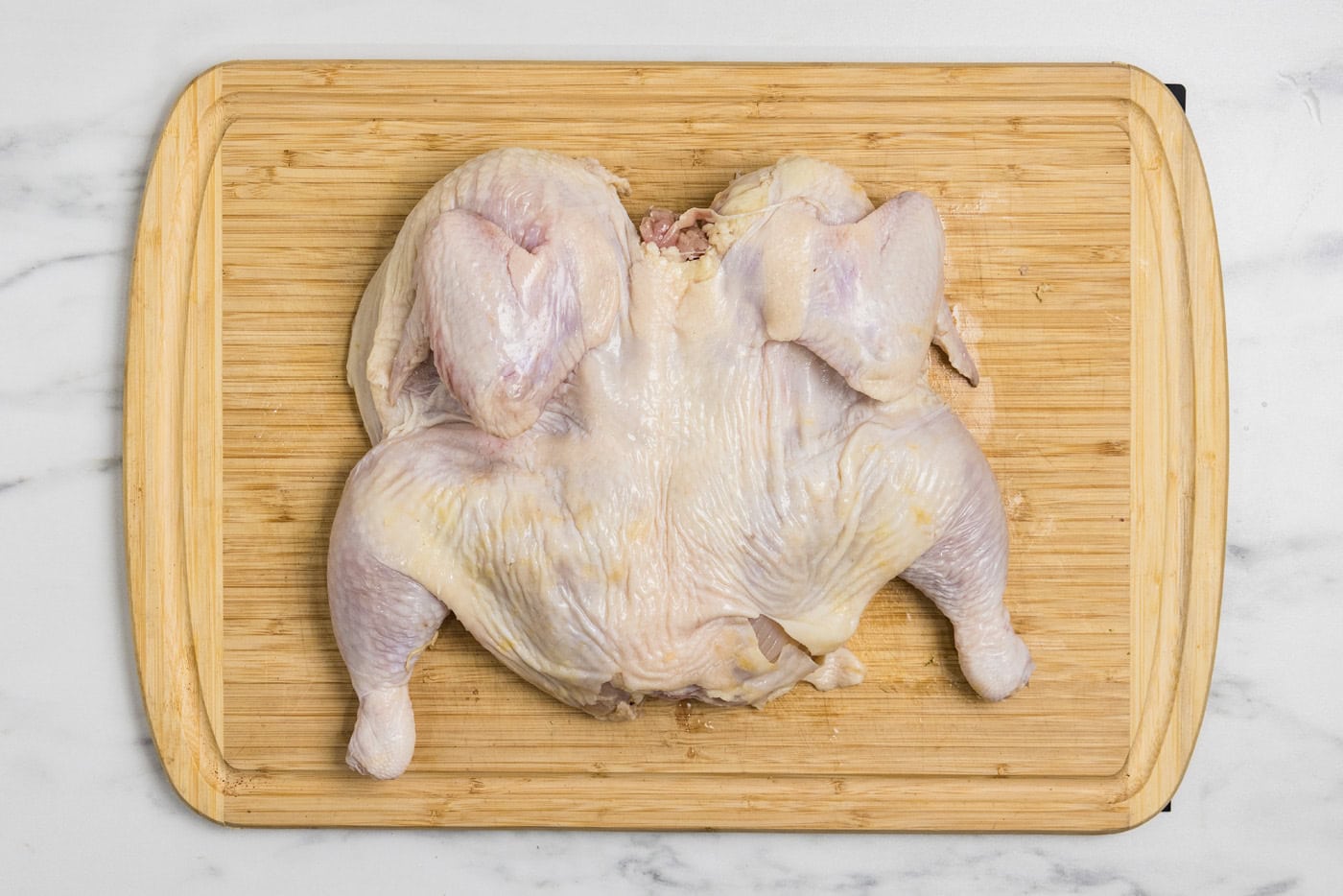 photo of spatchcock chicken on a cutting board