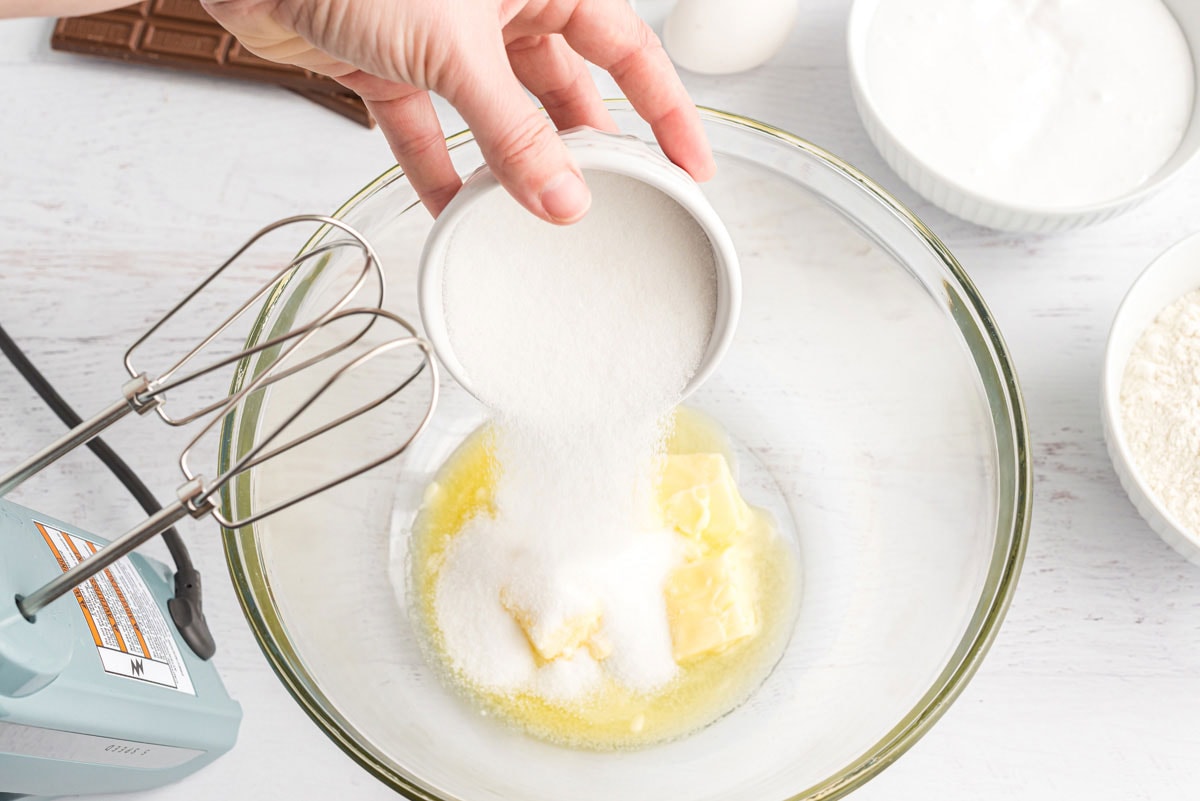 adding sugar to the bowl