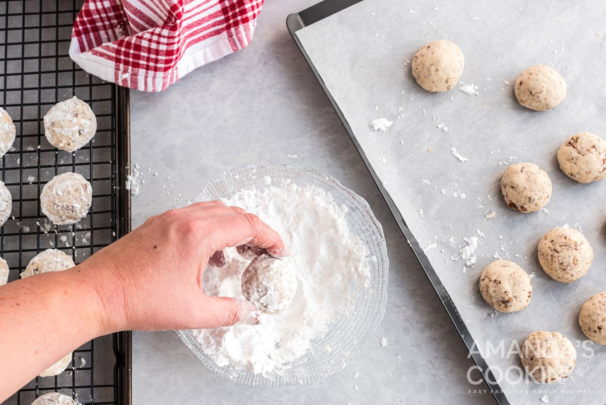 rolling cookies in powdered sugar