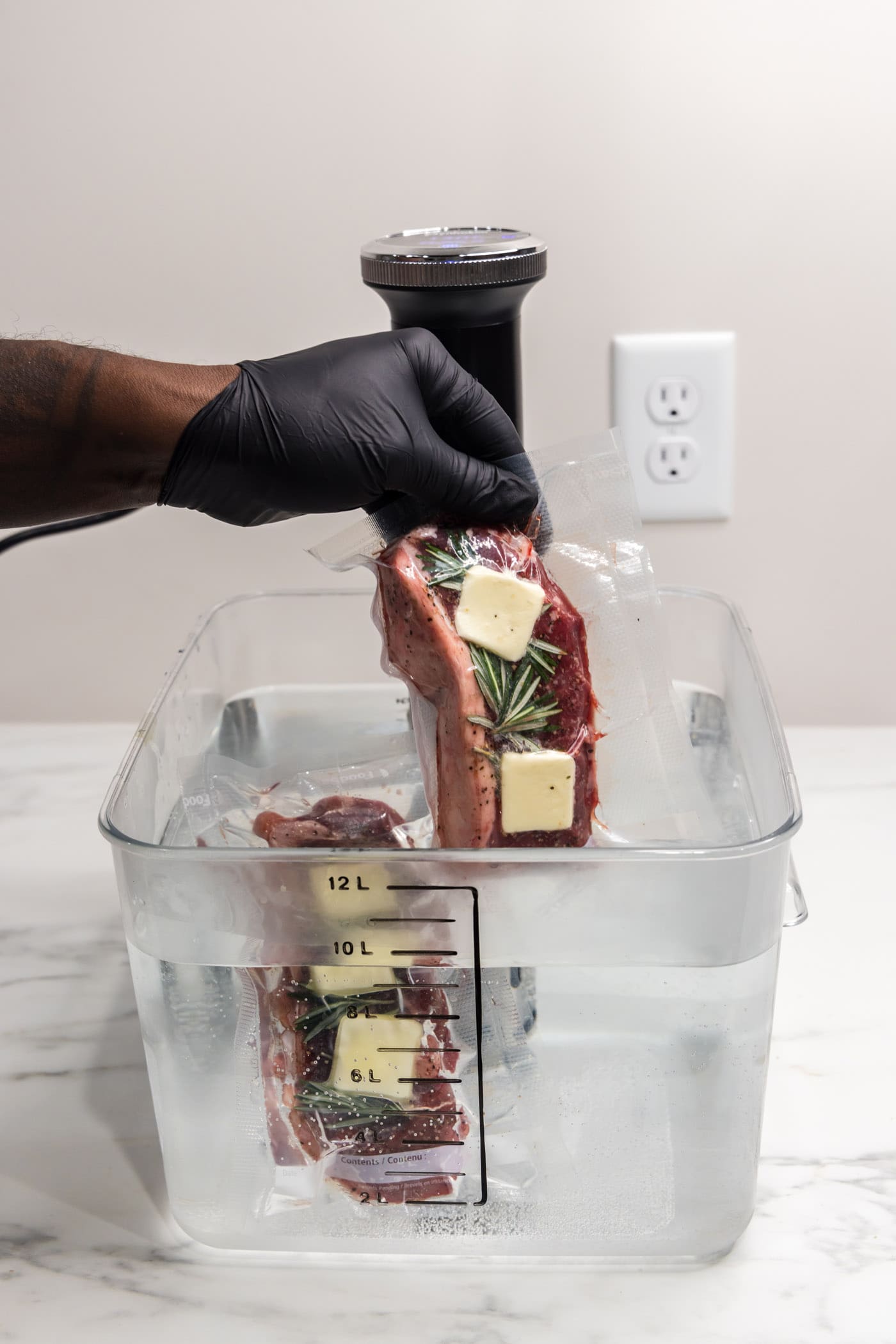 Sous Vide Steak being dropped into the Sous Vide container