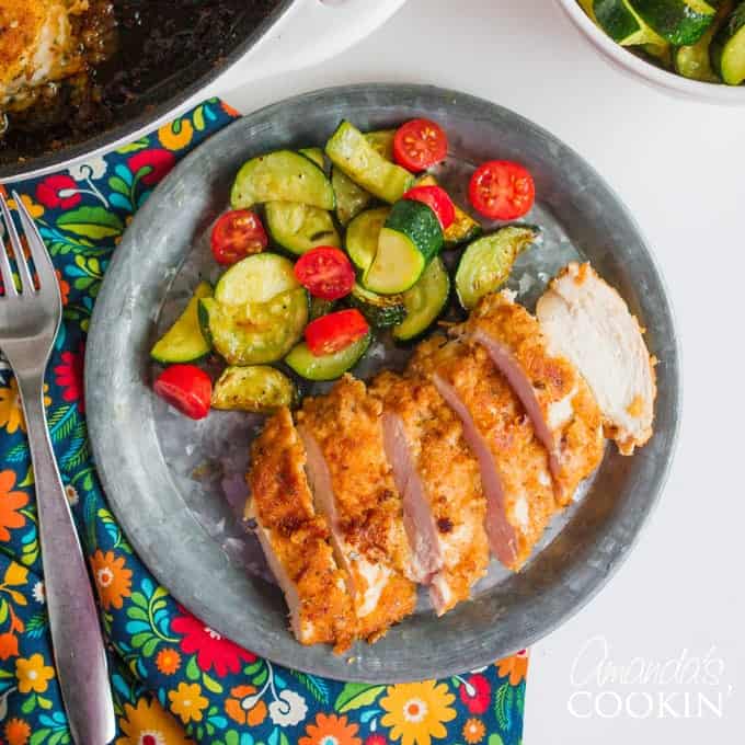 spicy oven fried chicken on a plate with side salad