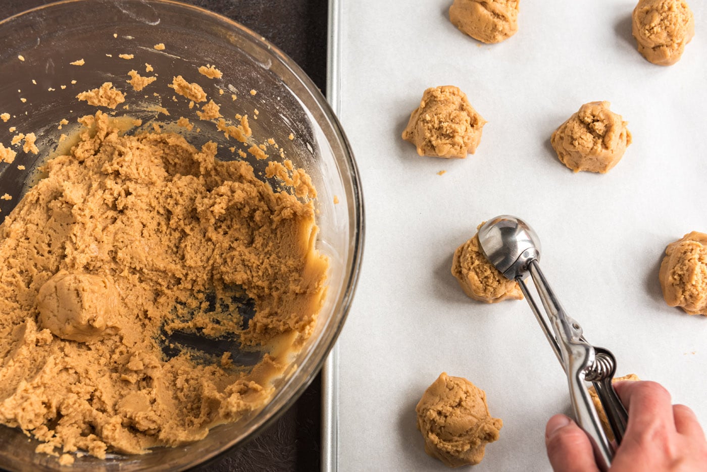 scooping cookie dough onto baking sheet