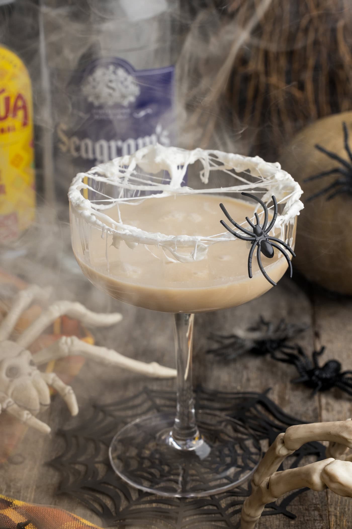 Spiderweb Cocktail with smoke in the background