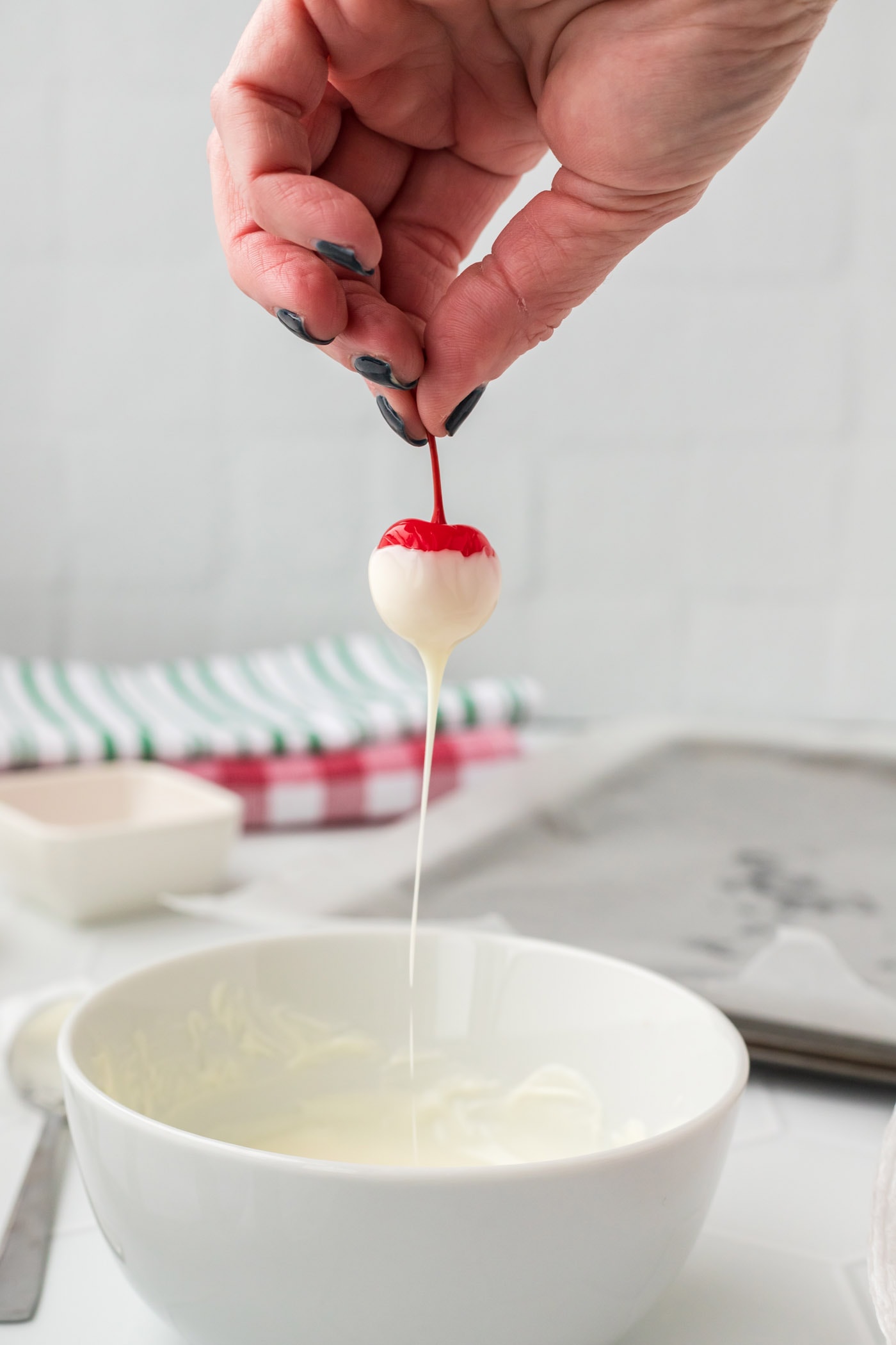 dipping boozy cherry into chocolate